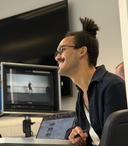 two men working in a production studio with a camera and a computer