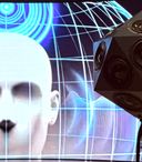 A multi-directional dodecahedron loudspeaker array stands in front of a digital display featuring a stylised human head and blue sound wave graphics, illustrating immersive spatial audio technology.
