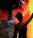 person dancingg infront of interactive led screen with vivid yellow, red, and orange tones