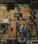 A musician performing with cameras capturing their movements, representing the CoSTAR Live Lab Intelligent Venues funding call
