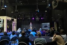 Photo from a Presents event of a speaker on stage in front of an audience