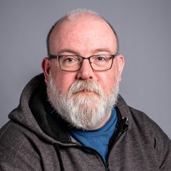 A man with glasses and a beard