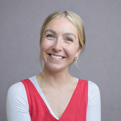 A smiling woman with a red top 