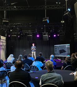 Photo from a Presents event of a speaker on stage in front of an audience