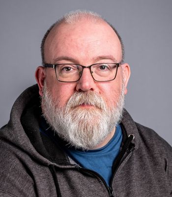A man with glasses and a beard