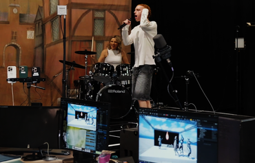 LiveLab_Aldag woman drummer and man guitarist in AV studio