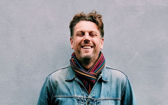 ed-jenkins-headshot man in blue jacket smiling at camera