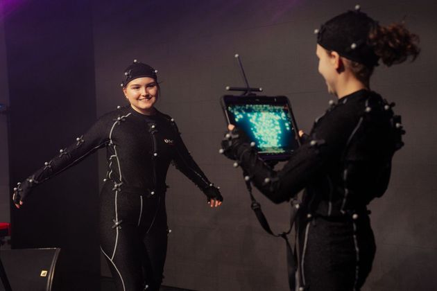 Two performers wearing motion capture suits during a session at the CoSTAR Live Lab, University of York and Production Park, February 2025