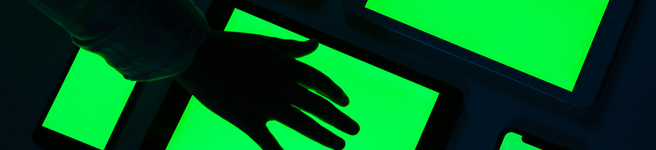 someones hand in silhouette on a bright green lit floor light box