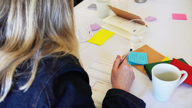 woman at a table filling in a form