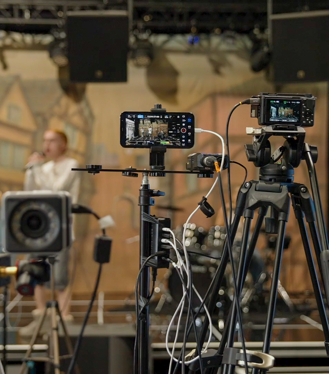A musician performing with cameras capturing their movements, representing the CoSTAR Live Lab Intelligent Venues funding call