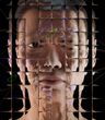 A photographic rendering of a simulated middle-aged white woman against a black background, seen through a refractive glass grid and overlaid with a distorted diagram of a neural network.