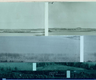 This image shows a fragmented panorama of a serene Finnish landscape, divided into four horizontal sections. The topmost section shows a distant shoreline dotted with buildings and rolling hills, painted in muted green-blue hues. Below, a body of water stretches across the frame. The third and fourth section show a zone of tall grass at the water's edge and some foliage from trees. The image color palette shifts subtly from pale aqua at the top to deeper teal tones at the bottom. This fragmented presentation of the landscape evokes thoughts of memory, perception, and the layered nature of our relationship with the environment.