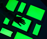 someones hand in silhouette on a bright green lit floor light box
