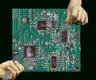 Two ceramic-like hands grip and pull on delicate threads that emerge from a "woven circuit board." The contrast between the rigid, heavy material of the hands and the soft, fragile threads creates a visual paradox, symbolising the insertion of human touch into the mechanised world. The image evokes a sense of personified anonymity, questioning whose histories and labours are being revealed or concealed when the threads of technology are pulled.