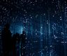  A person in a darkened space surrounded by large immersive digital projections, representing the kind of audience experiences being shaped by CoSTAR AI research